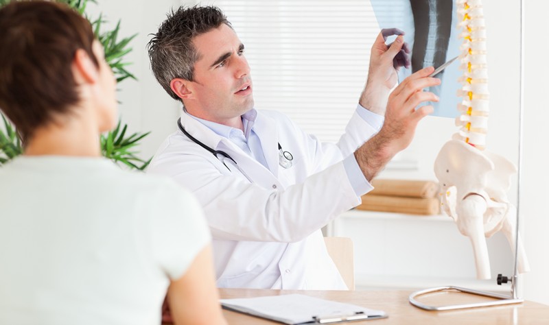 Male Doctor showing a patient a x-ray